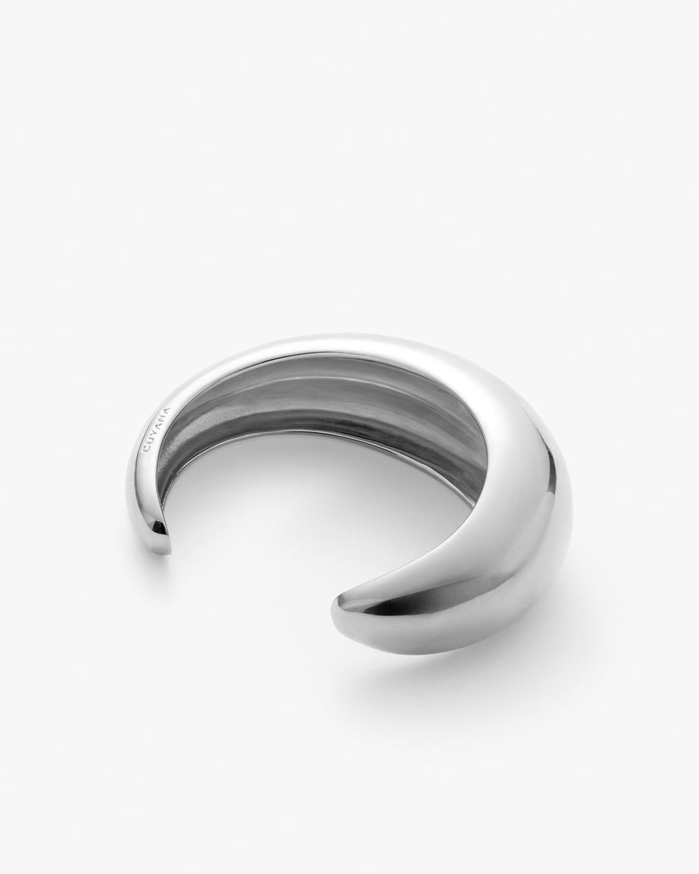 Curved bracelet on a plain background.