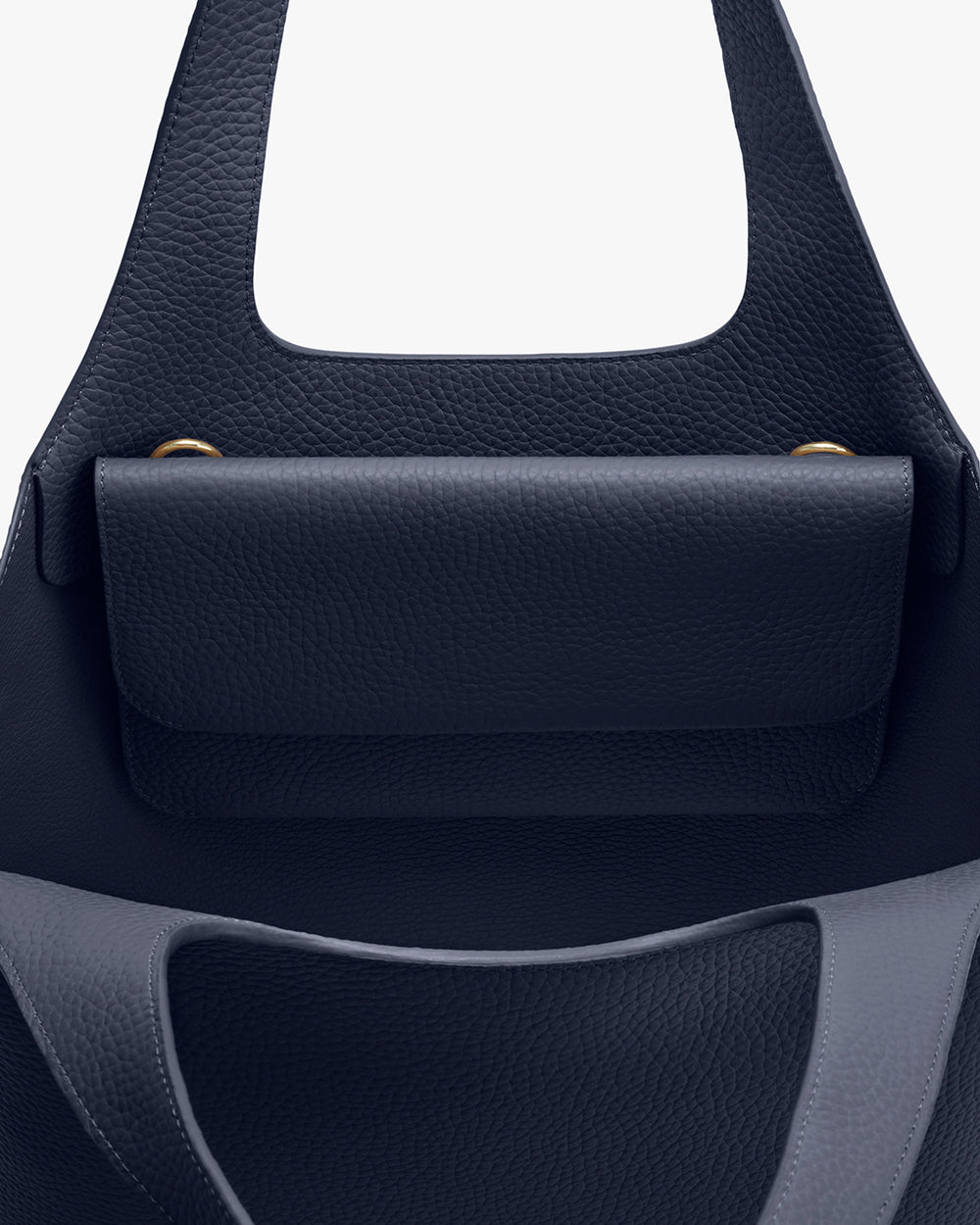 Close-up view of a handbag with a flap closure and handle.