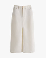 Long skirt with front slit, a button closure, and pockets.