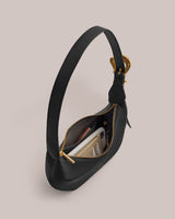 Handbag with an open zipper revealing contents inside.