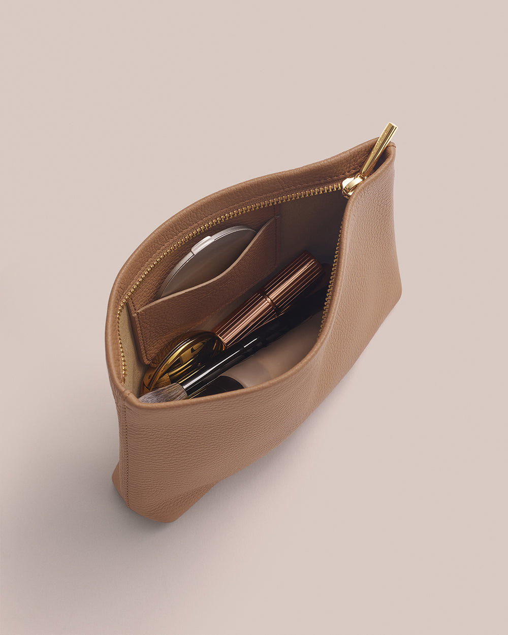 Open pouch with makeup items inside.
