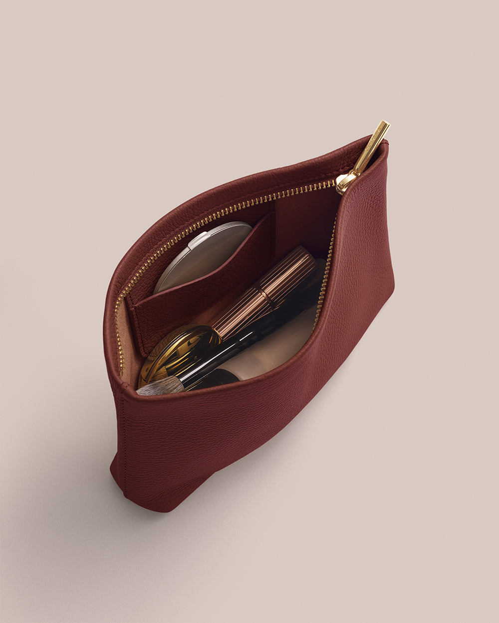 Open pouch with cosmetics inside