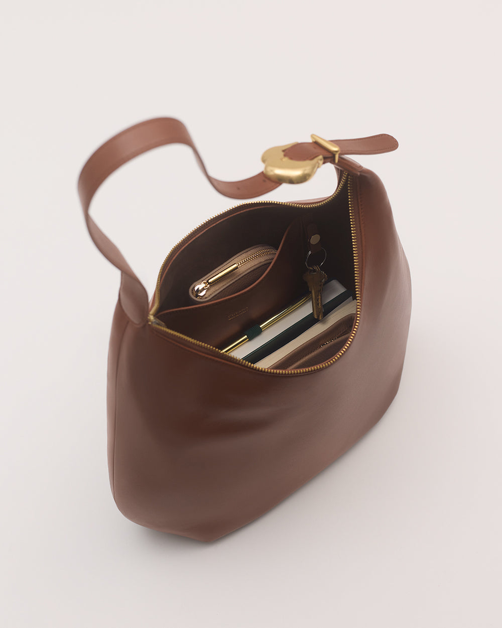 Open handbag with contents including a wallet and keys visible