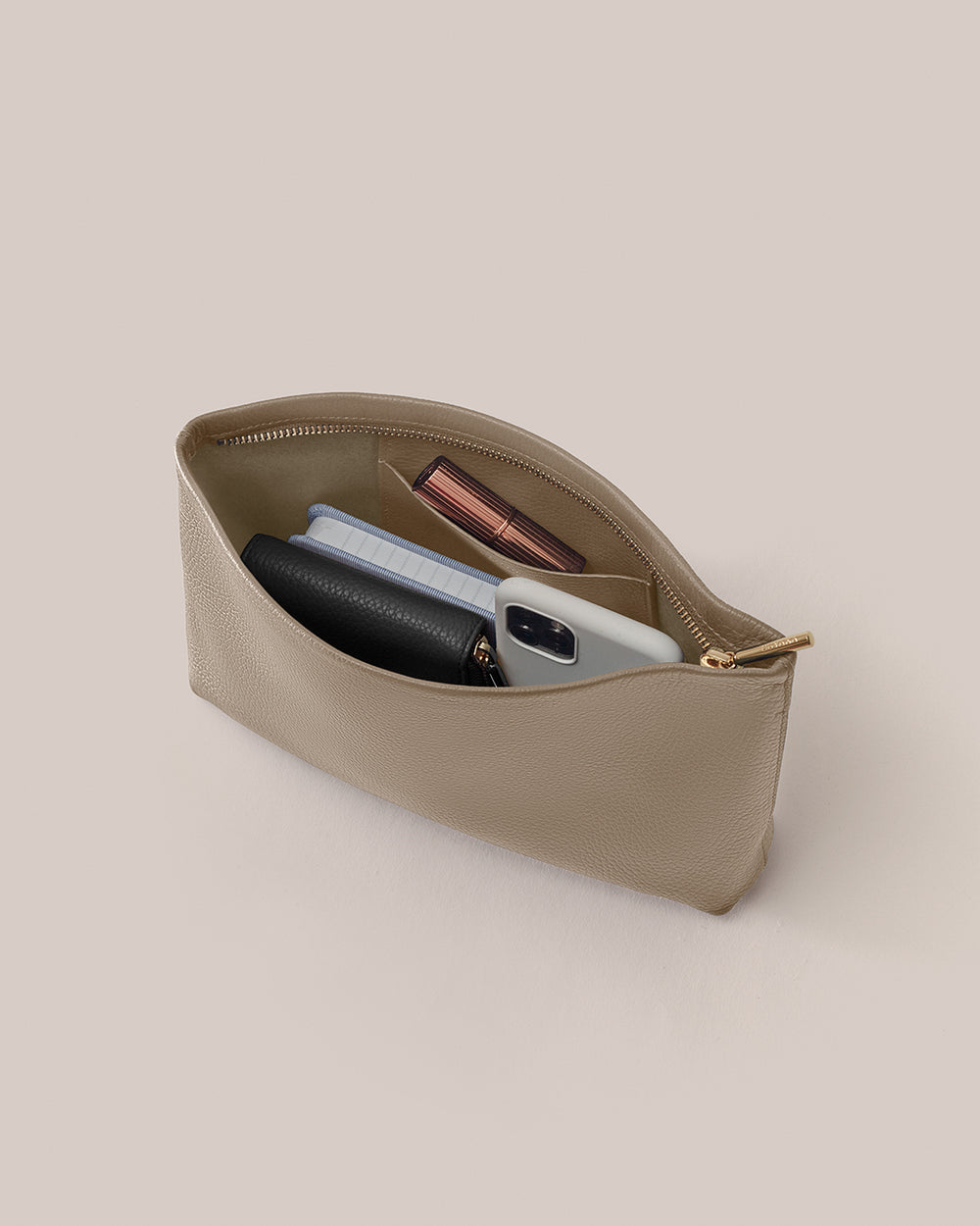 Open pouch with phone, wallet, and other small items inside