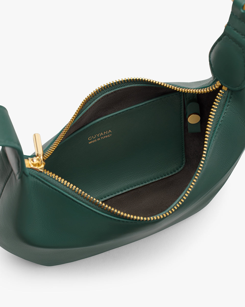 Open handbag with gold zipper showing a small interior pocket.