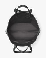 Open backpack viewed from the top with visible handles and straps.