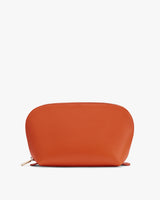 Small zippered pouch standing on a plain surface.