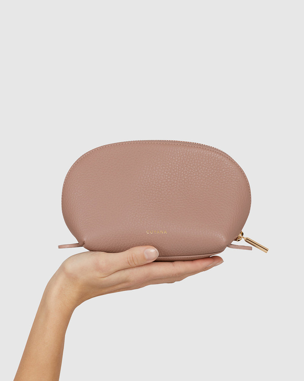 Hand holding a small zippered pouch.