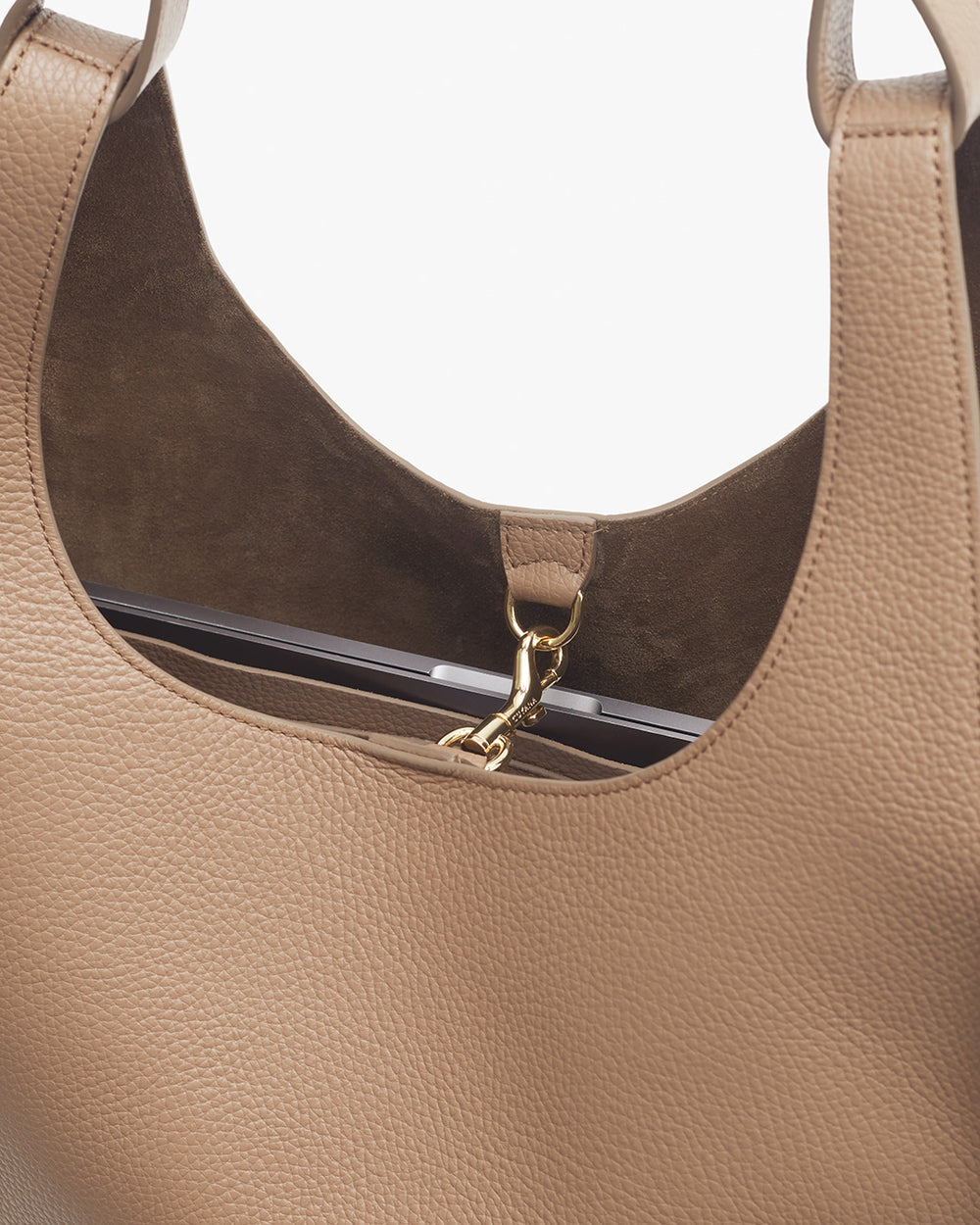 Top inside part of a handbag showing clasp and stitching details.