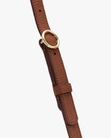 Bag strap with gold ring buckle and adjustable feature.