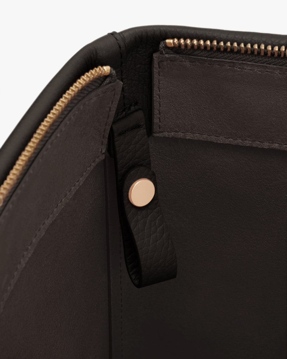 Close-up of a bag's interior with a zipper and button detail