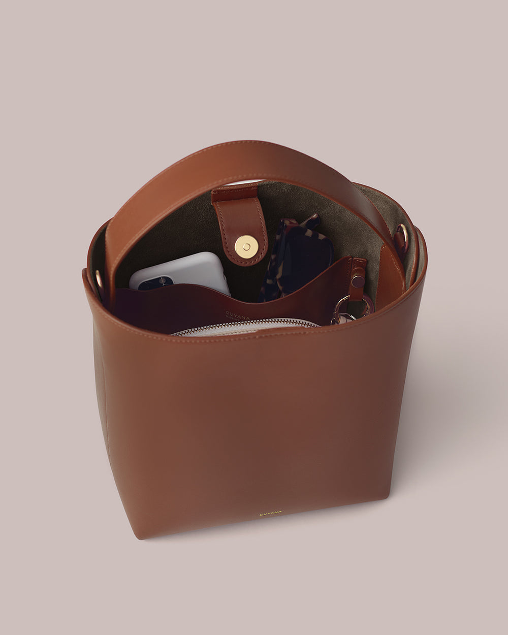Open handbag containing a phone and other small items