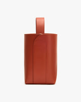 Leather bucket bag with a single handle on top.