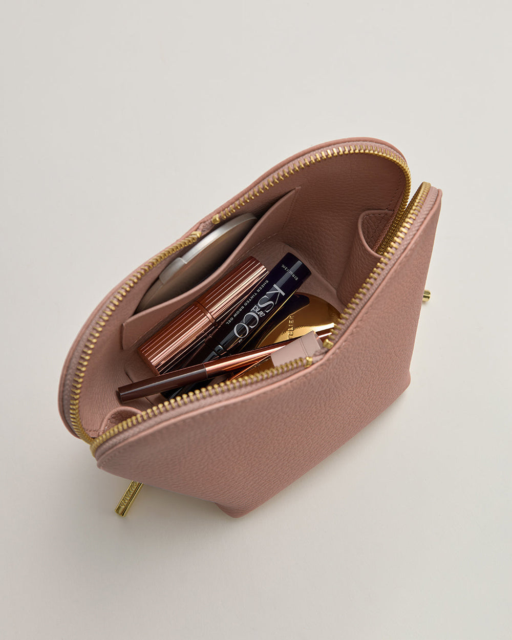 Open pouch with cosmetics and accessories inside