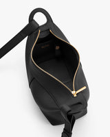 Open handbag with gold zipper and shoulder strap.