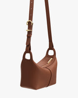 Shoulder bag with curved shape and adjustable strap.