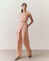 Woman walking in sleeveless top and wide-leg pants.