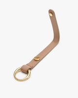 Leather key holder with metal ring and snap button.