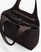 Open handbag with multiple compartments and a laptop sleeve inside