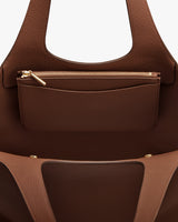 Open tote bag with zippered pouch inside and two handles.
