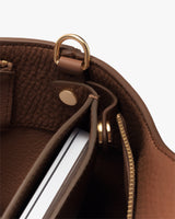 Open bag with a visible laptop inside and zipper detail.