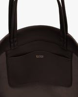 Close-up of a bag with dual handles and a small interor pocket
