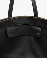 Open travel bag with handles and visible zipper edge
