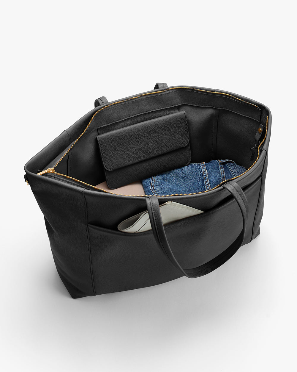 Open travel bag showing clothes and a wallet inside.