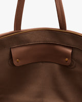 Open travel bag with visible interior pocket and zipper.