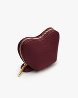 Heart-shaped small zippered pouch with a textured surface.