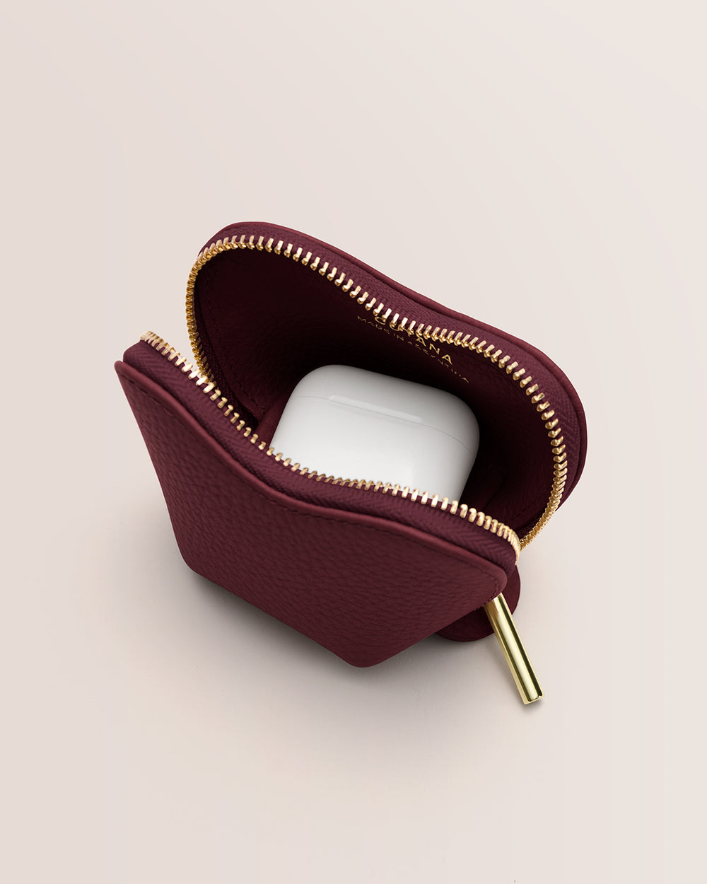 Pouch with a zipper partially open showing wireless earbuds inside.