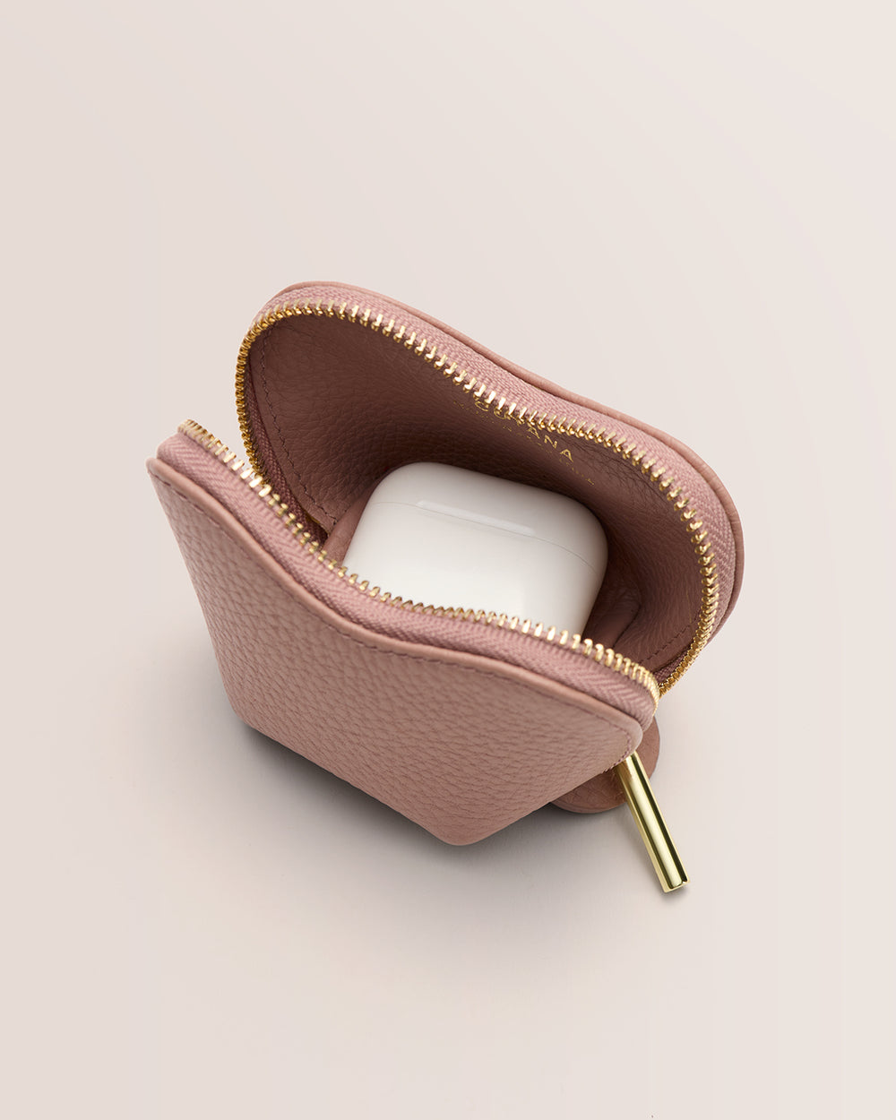 Small pouch with zipper, holding white case inside.