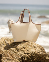 Tote bag placed on rocks by the seaside.