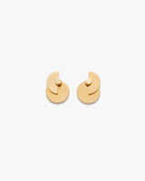 Geometric layered circular earrings on a plain background.