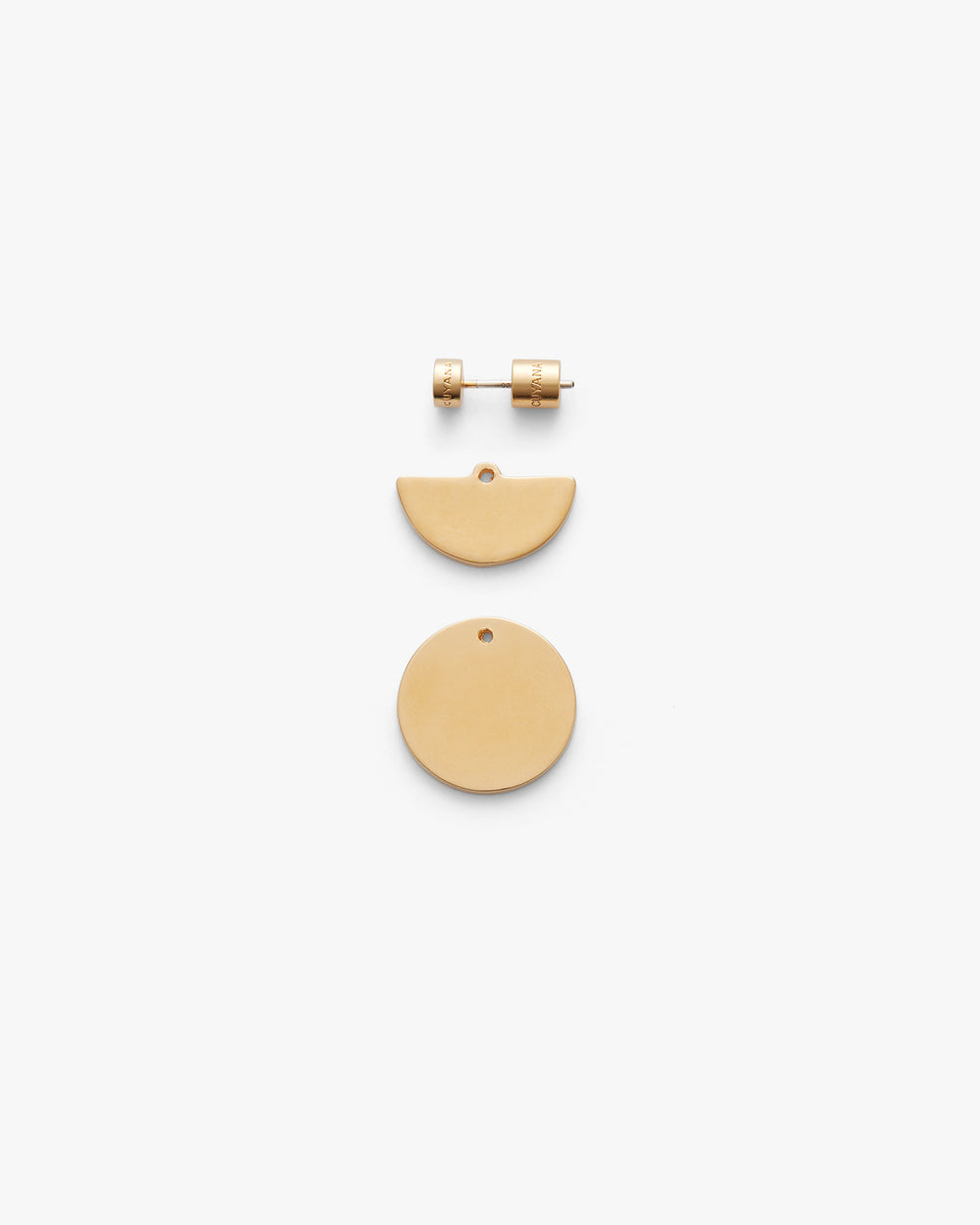 Set of three geometric earrings laid out flat.