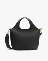 Handbag with rounded handles and a detachable shoulder strap.