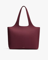 Tote bag with two handles and smooth texture.