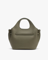Handbag with rounded handles and a textured surface.