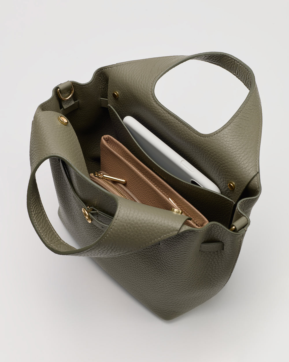 Open handbag with two pouches and a tablet inside.