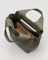 Open handbag with two pouches and a tablet inside.