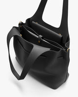 Open leather tote bag with multiple compartments and a handle.