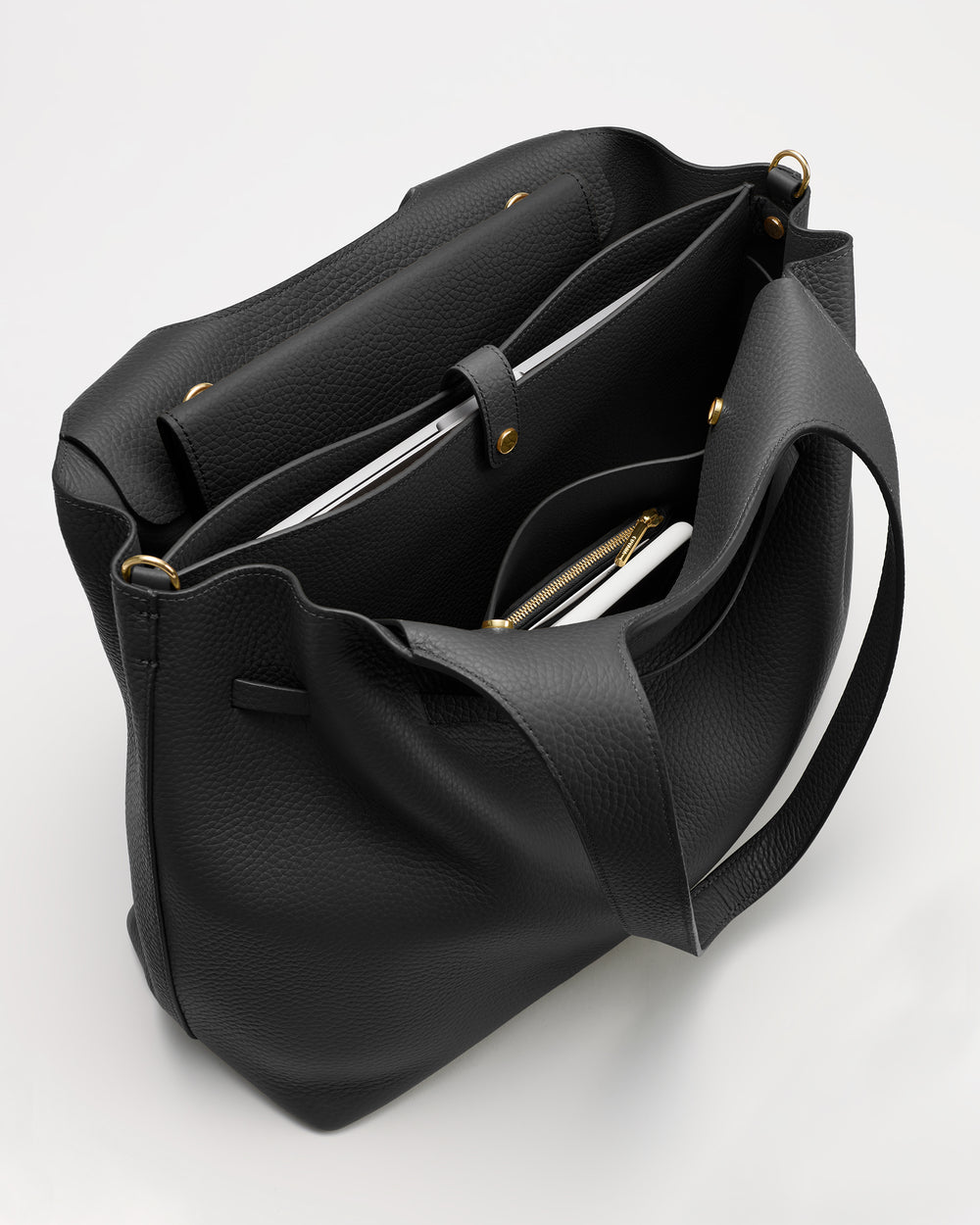 An open tote bag with multiple compartments and gold button accents.