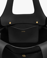 Open tote bag with interior pockets and gold snaps.
