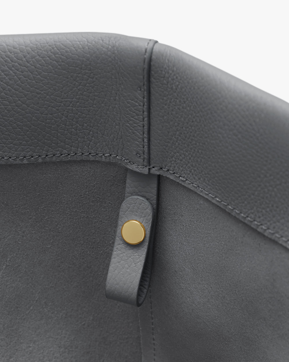 Close-up of a leather interior with a metal button detail.