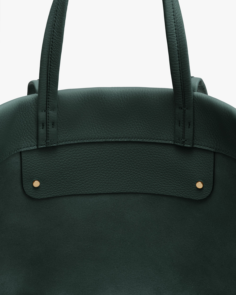 Close-up of the top part of a tote bag with handles and two rivets.
