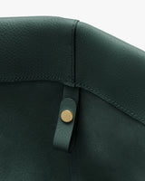 Close-up of leather bag interior with button detail.
