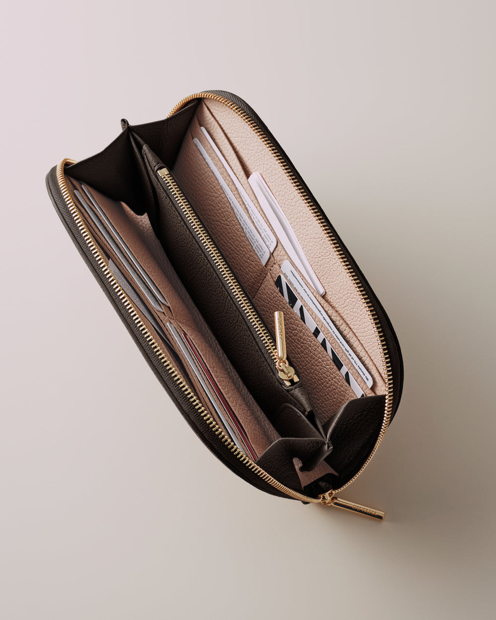 Open wallet with multiple card slots and a zipper compartment inside.