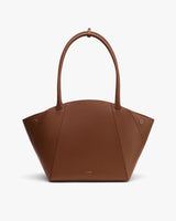 Handbag with an arched handle and geometric design.