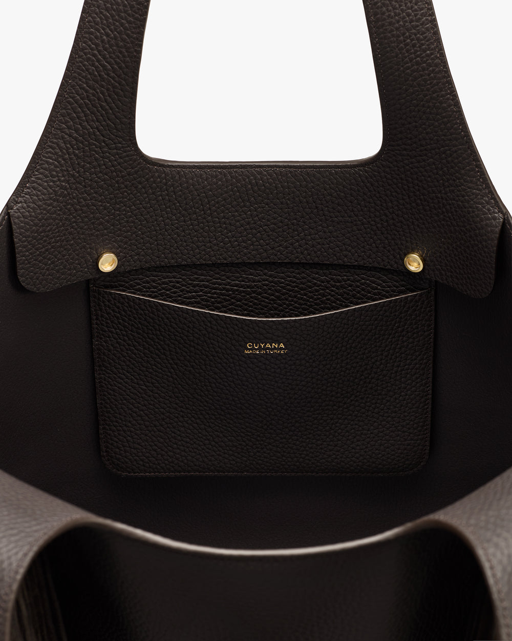 Open handbag with a pocket and gold buttons visible inside.
