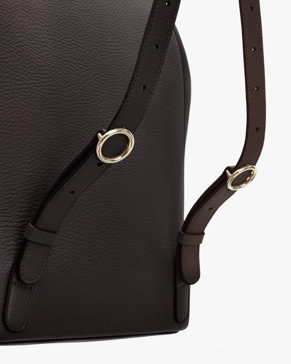 Close-up of a backpack with metal buckles and adjustable straps.
